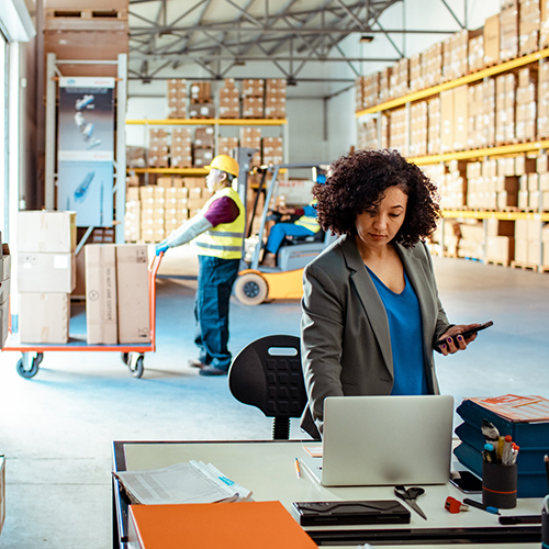 Warehouse team planning supply chain with packed cartons