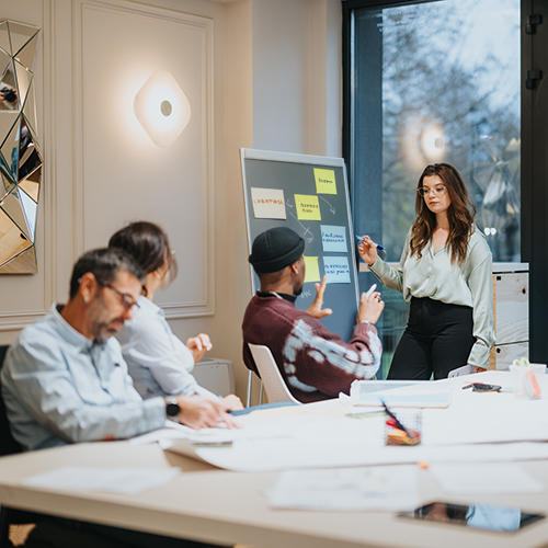 Team reviewing packaging specifications on a board